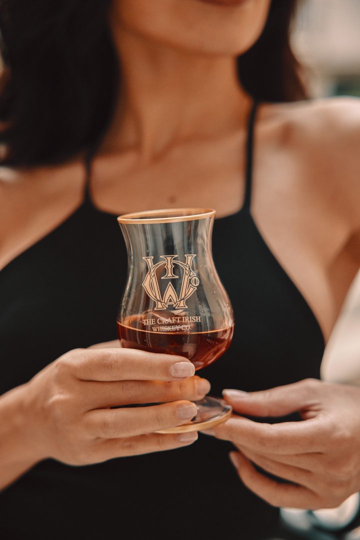 woman holding a glass of whiskey for women